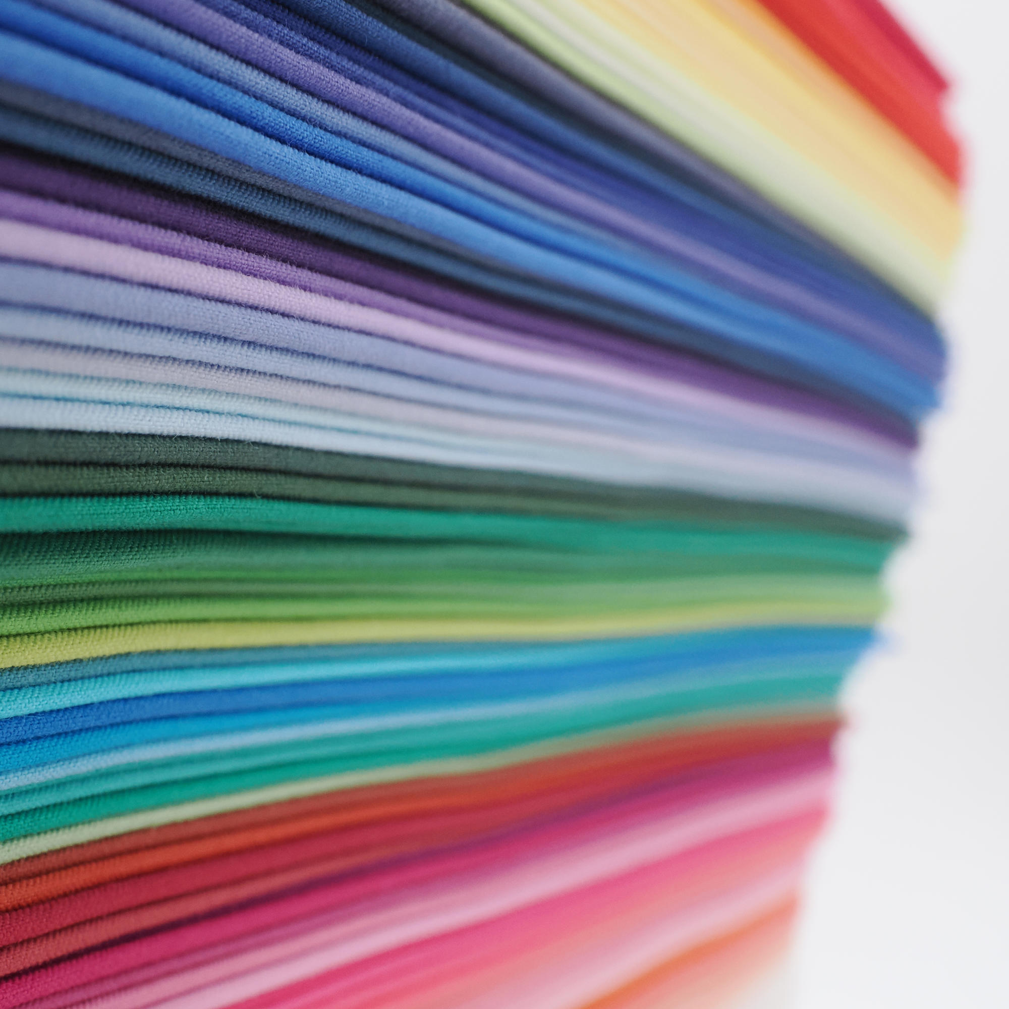 Close up of neat stack of bundle of 120 colours of direct colour drapes, close up