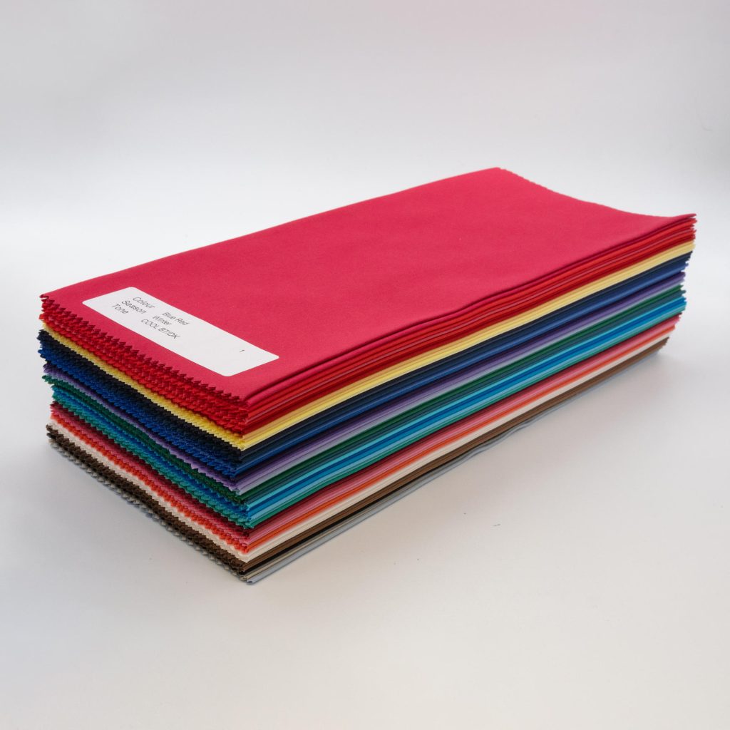 A neat stack of bundle of 60 of direct colour drapes, diagonal full image from side