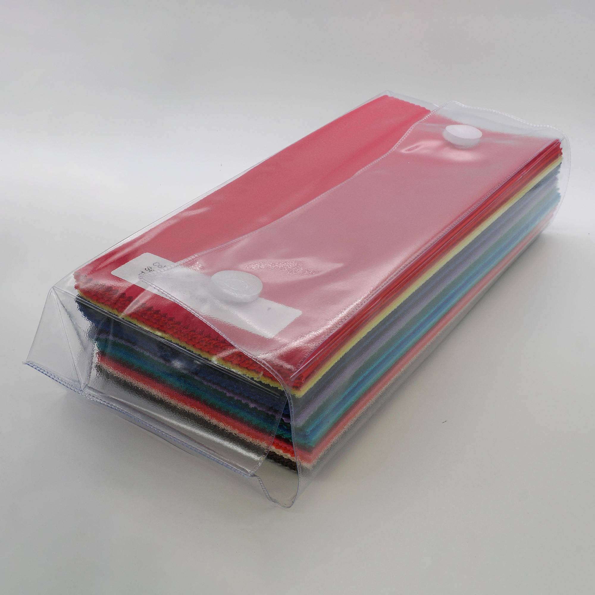 Neat stack of bundle of 60 colours of direct colour drapes wrapped ready for delivery