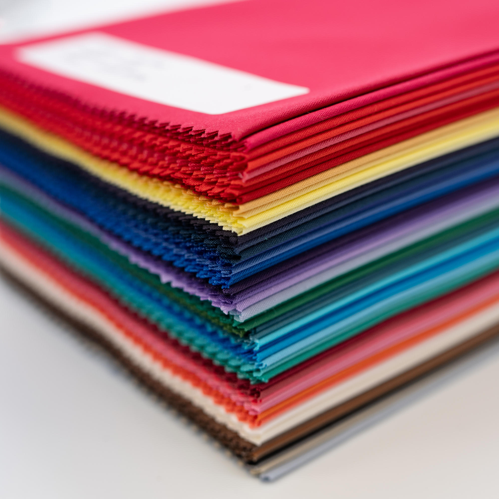 A neat stack of bundle of 60 of direct colour drapes, close up