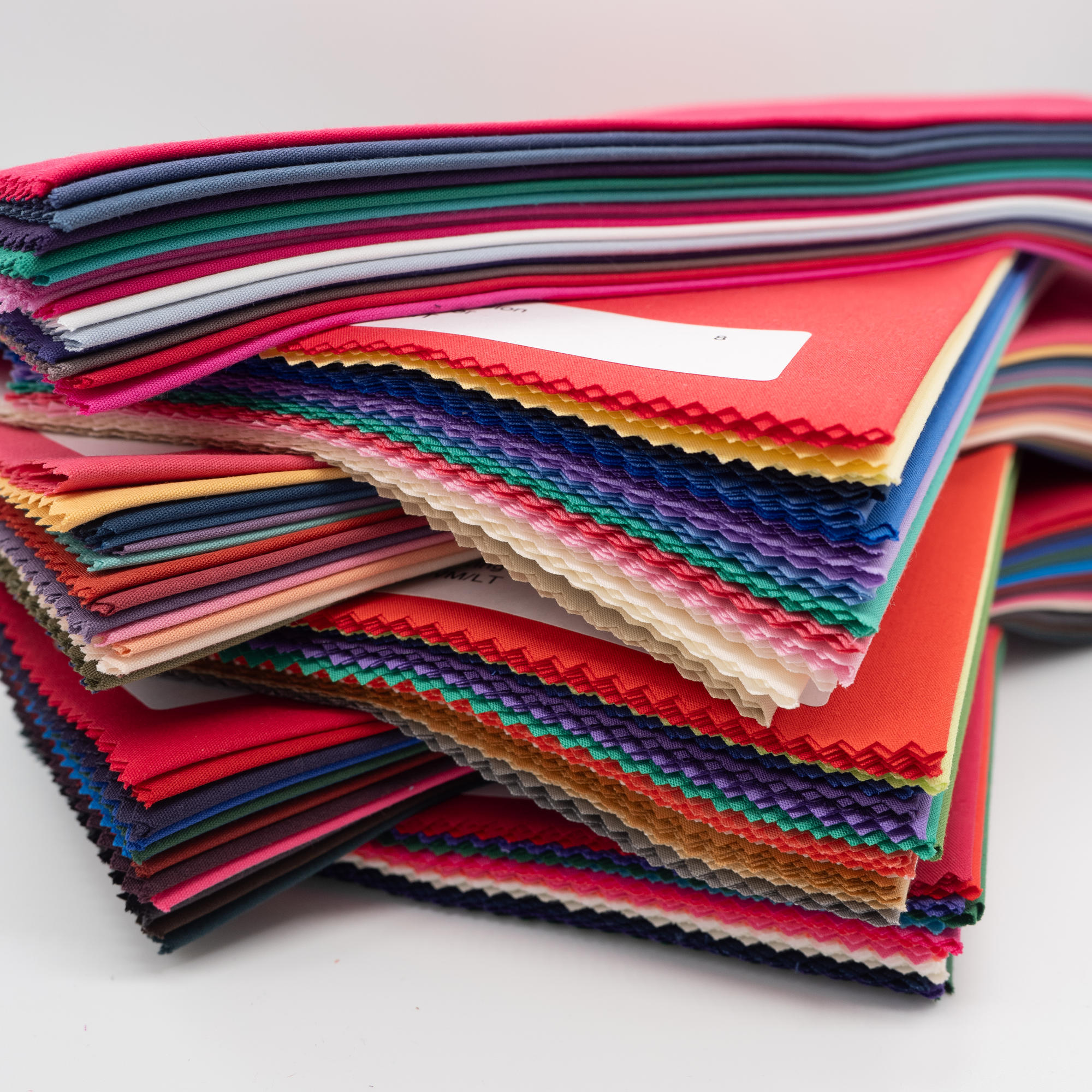 Crossways stack of all colours of direct colour drapes, close up